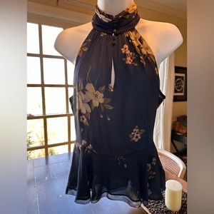 Joie navy/floral sleeveless blouse with peplum design at waist.  Size 2